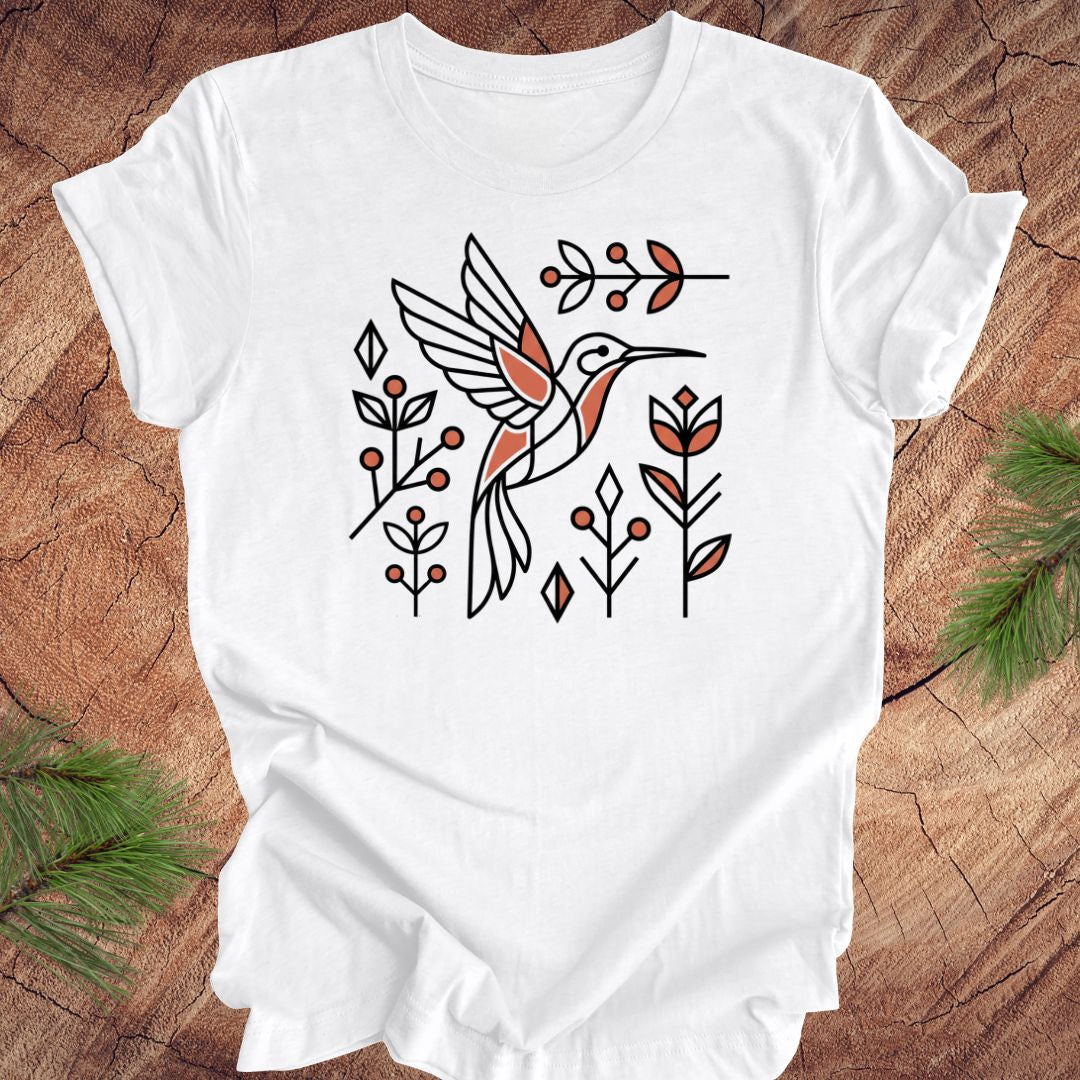 White baby romper with a hummingbird design on a wooden surface