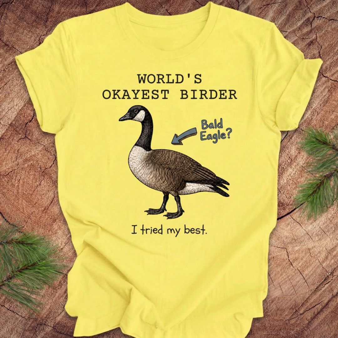 Yellow t-shirt with a goose graphic and text on a wooden surface