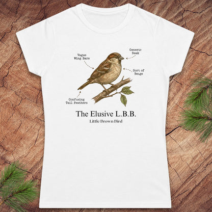 A white short-sleeve crewneck t-shirt with a humorous bird illustration printed on the front. The graphic shows a brown sparrow perched on a branch with labels pointing to its features, followed by the text 'The Elusive L.