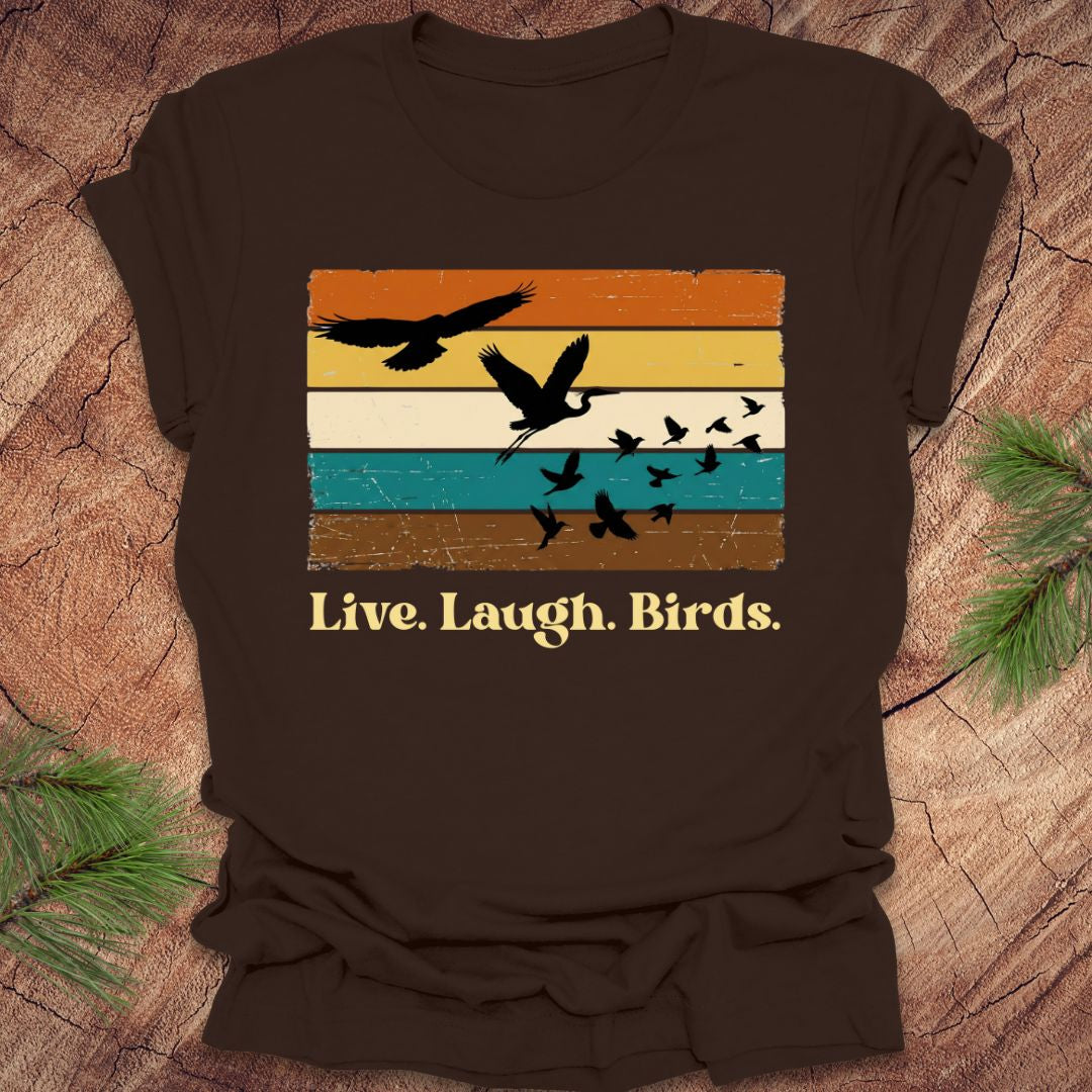 Brown t-shirt with bird graphic and 'Live. Laugh. Birds.' text on a wooden surface.