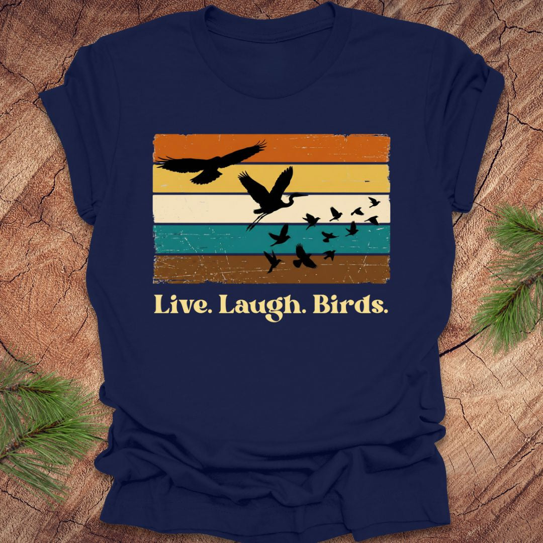 Navy blue t-shirt with bird graphic and 'Live. Laugh. Birds.' text on a wooden surface.
