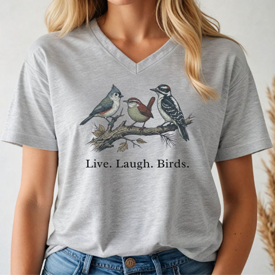 Person wearing a gray v-neck t-shirt with bird illustration and 'Live. Laugh. Birds.' text.