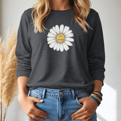 Person wearing a dark gray long-sleeve tshirt with a white flower graphic and 'live simply' text, standing against a neutral background.