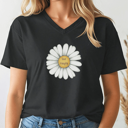Black v-neck t-shirt with a white flower design and 'live simply' text, worn by a person.