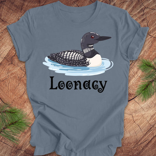 Blue t-shirt with a loon graphic and 'Loonacy' text on a wooden surface.