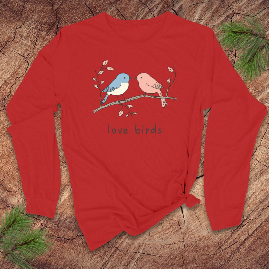 Red long-sleeve shirt with 'love birds' design on a wooden surface