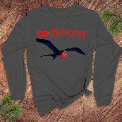 Gray long-sleeve shirt with a frigatebird graphic and 'MAGNIFICENT' text on a wooden surface.