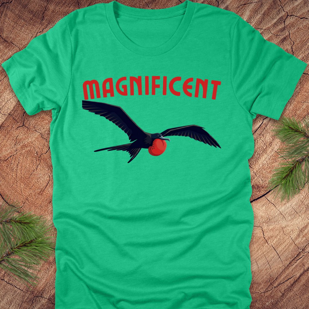 Green t-shirt with a bird graphic and 'MAGNIFICENT' text on a wooden surface.