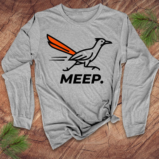 Gray long-sleeve shirt with a graphic of a roadrunner and 'MEEP.' text on a wooden surface.