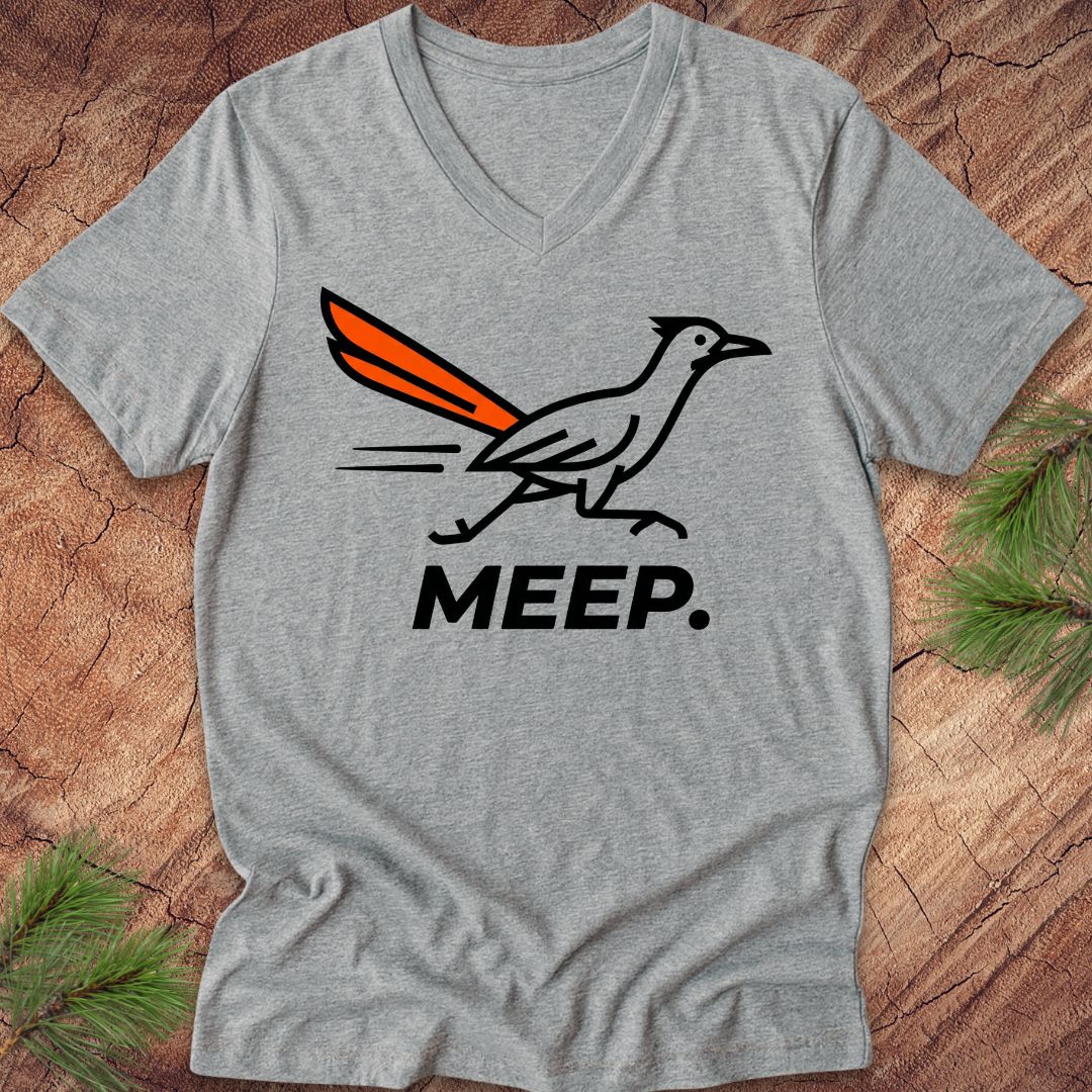 Gray  v-neck t-shirt with a graphic of a roadrunner and 'MEEP.' text on a wooden surface.