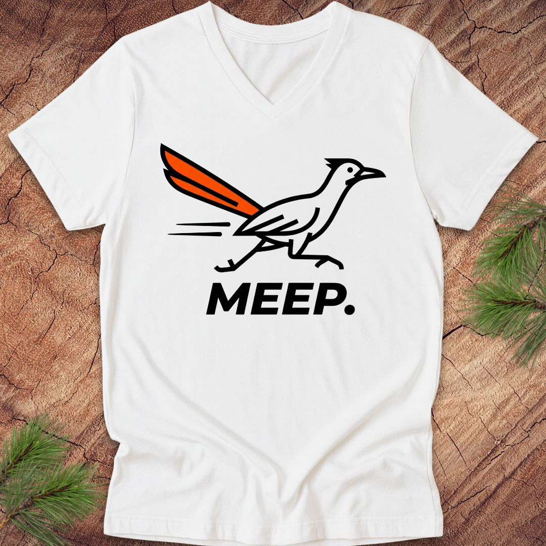 White  v-neck t-shirt with a graphic of a roadrunner and 'MEEP.' text on a wooden surface.
