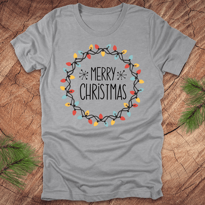 Gray t-shirt with 'Merry Christmas' design on a wooden surface