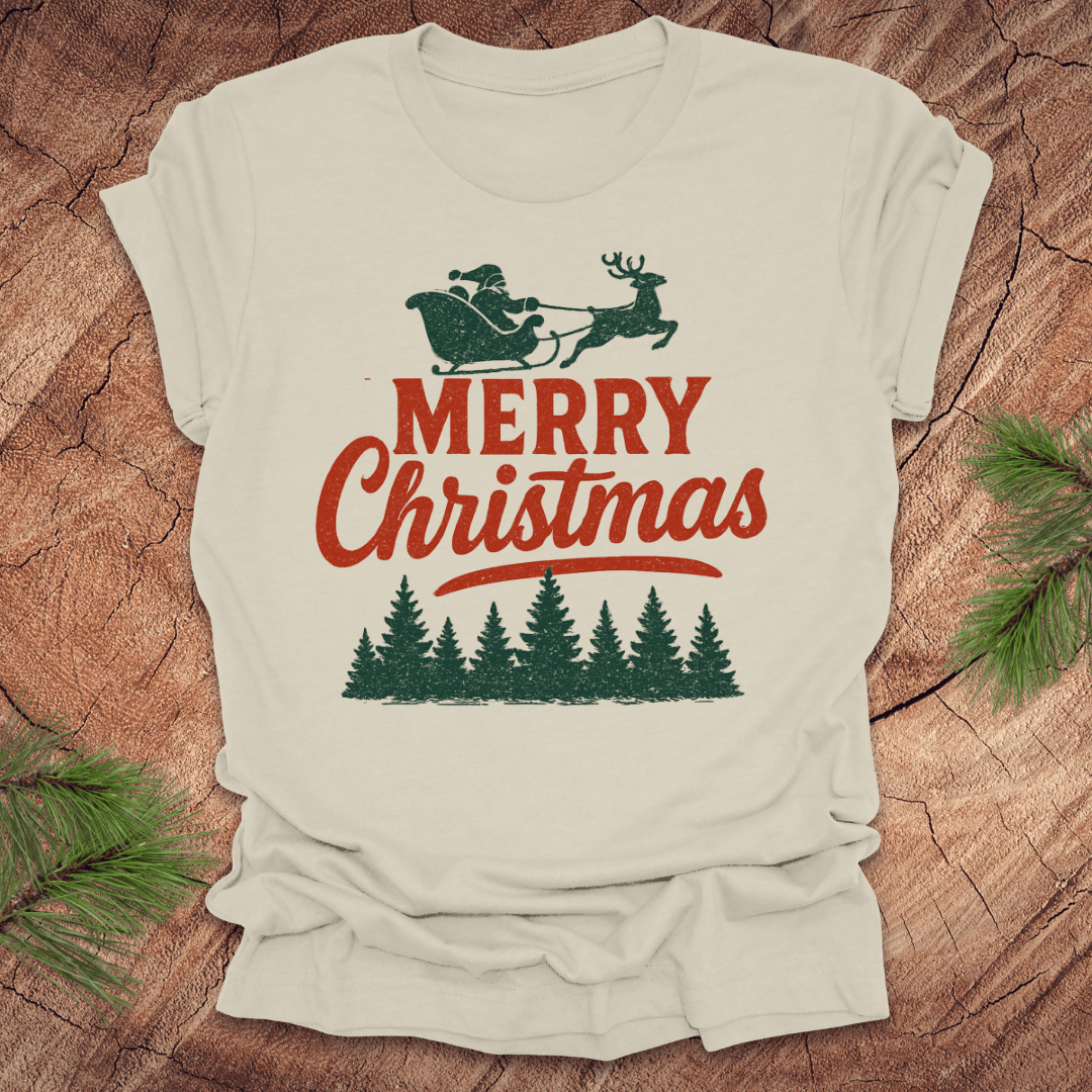 Beige t-shirt with 'Merry Christmas' design featuring Santa and reindeer on a wooden surface.