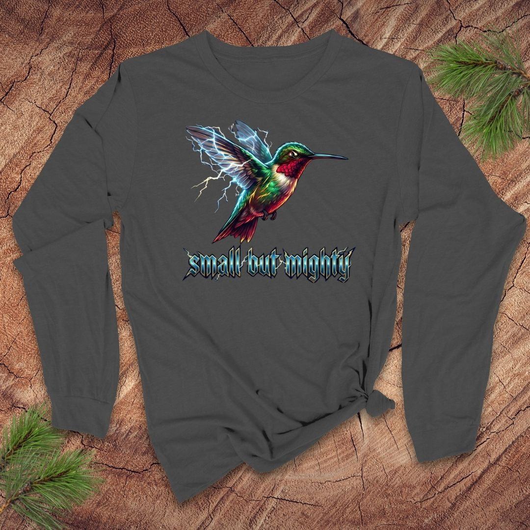 Gray long-sleeve shirt with a lightning hummingbird design and 'small but mighty' text on a wooden surface.