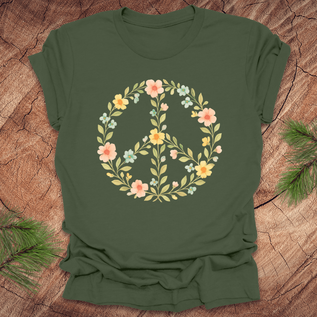 Green t-shirt with a peace sign made of flowers on a wood background.