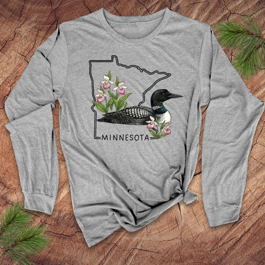 Gray long-sleeve shirt with Minnesota loon and flower design on a wooden surface
