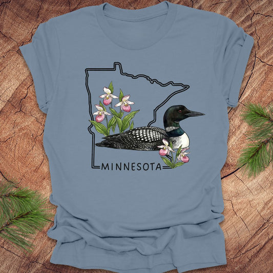 Steel blue t-shirt with Minnesota state outline and loon design on a wooden surface