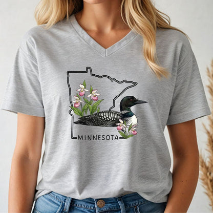 Person wearing a gray t-shirt with a Minnesota-themed graphic design.