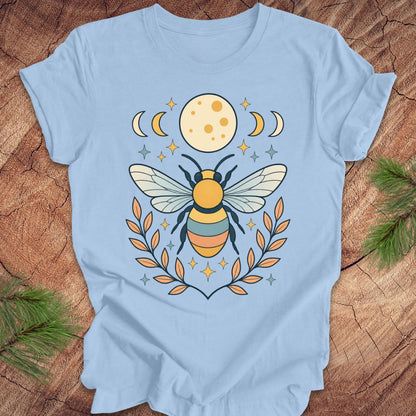 Light blue t-shirt with a bee design on a wooden surface
