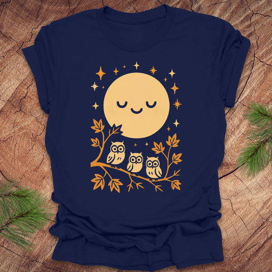 Navy blue t-shirt with a yellow moon and owl design on a wooden surface.