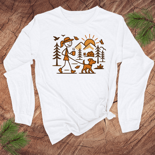 White long-sleeve shirt with a graphic design of a person walking a dog in a forest on a wooden surface.
