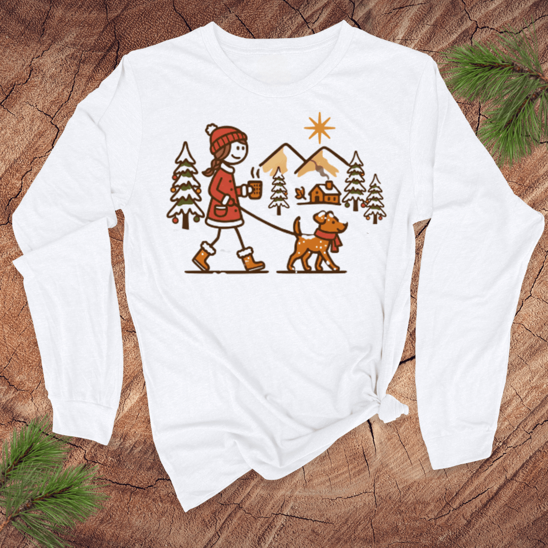 White long-sleeve shirt with a Christmas-themed graphic of a person walking a dog in the snow.