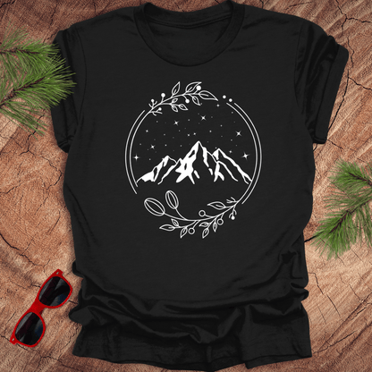 Black t-shirt with a graphic of a serene mountain scene surrounded by a circular frame, with stars and foliage accents.