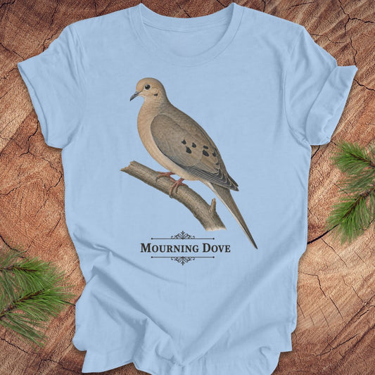 Blue t-shirt with a mourning dove bird and text on a wood background.