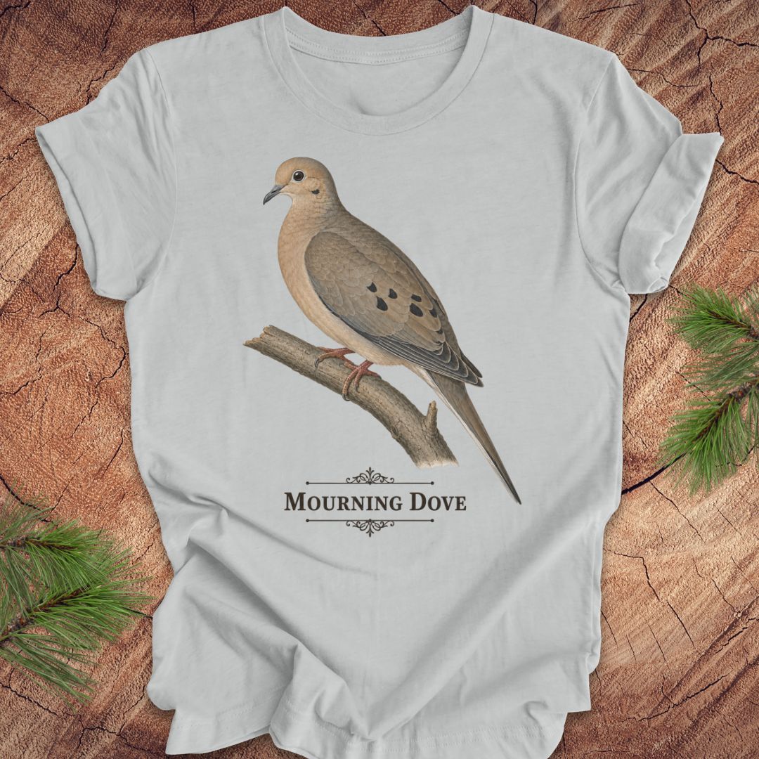 Gray t-shirt with a mourning dove bird and text on a wood background.