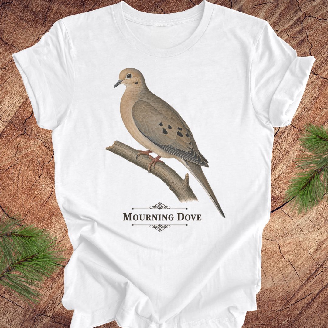 White t-shirt with a mourning dove bird and text on a wood background.