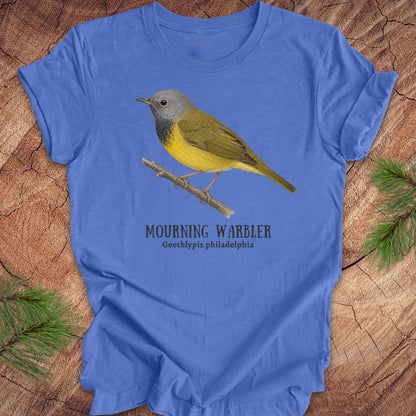 Blue t-shirt with a mourning warbler illustration and text on a wooden surface