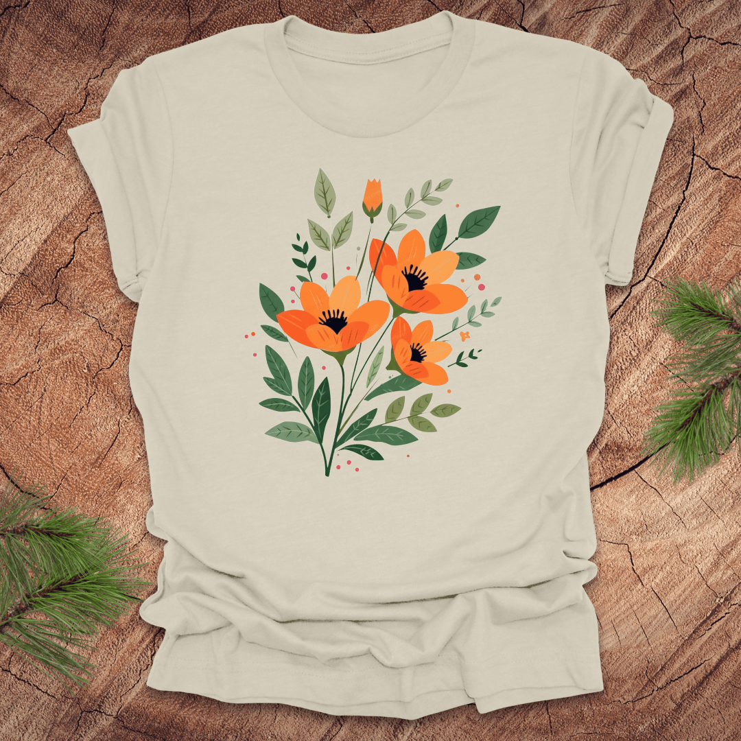 Beige t-shirt with orange floral design on a wooden surface