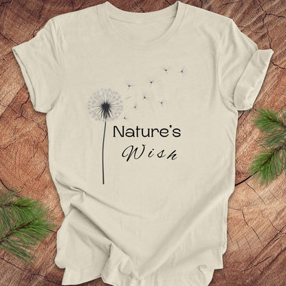 Beige t-shirt with 'Nature's Wish' text and dandelion graphic on a wooden surface.
