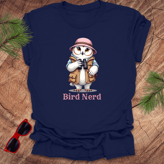 Navy blue t-shirt with an animated snowy owl in birdwatching gear with "bird nerd" text on a wood background.