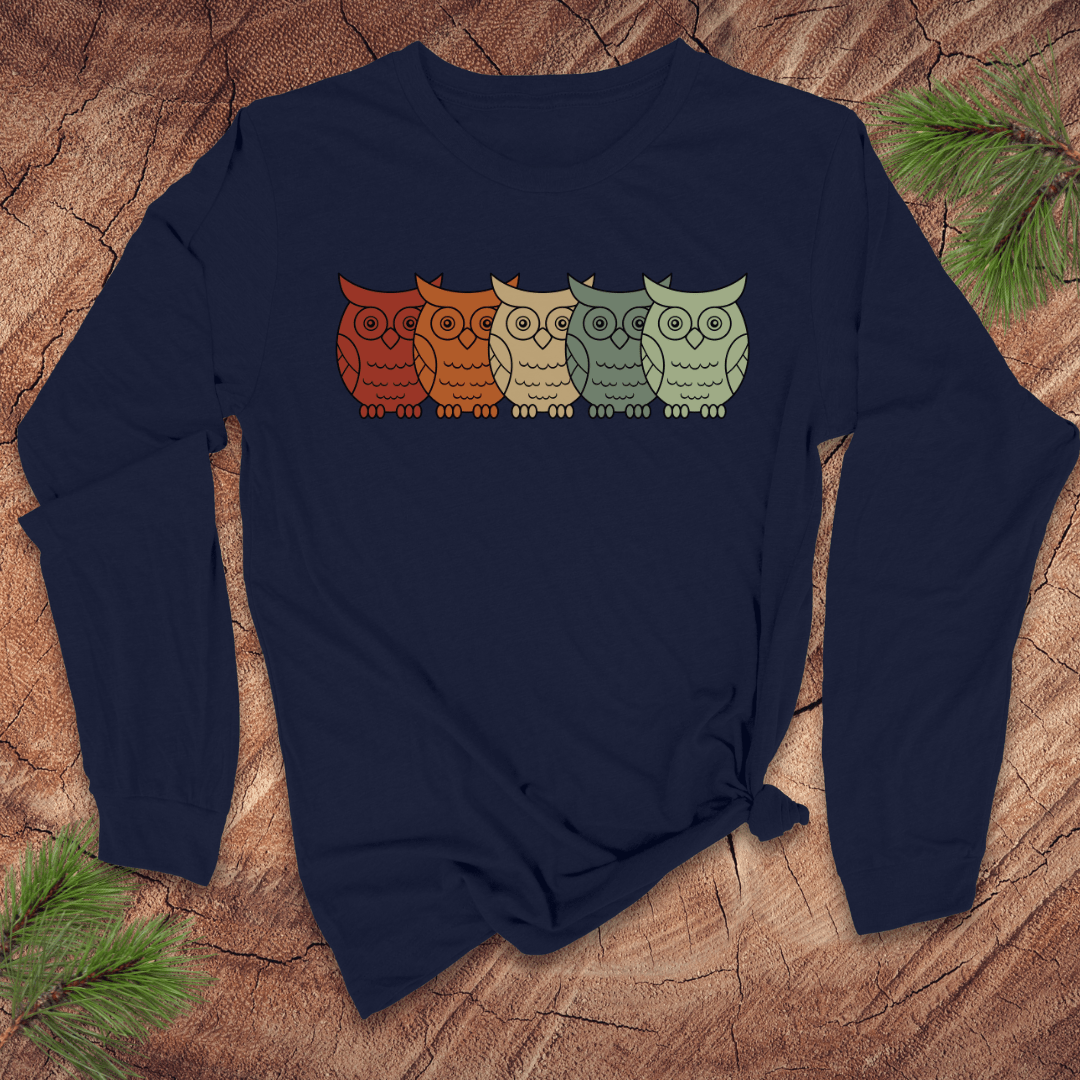 Navy blue long-sleeve shirt with colorful owl design on a wooden surface
