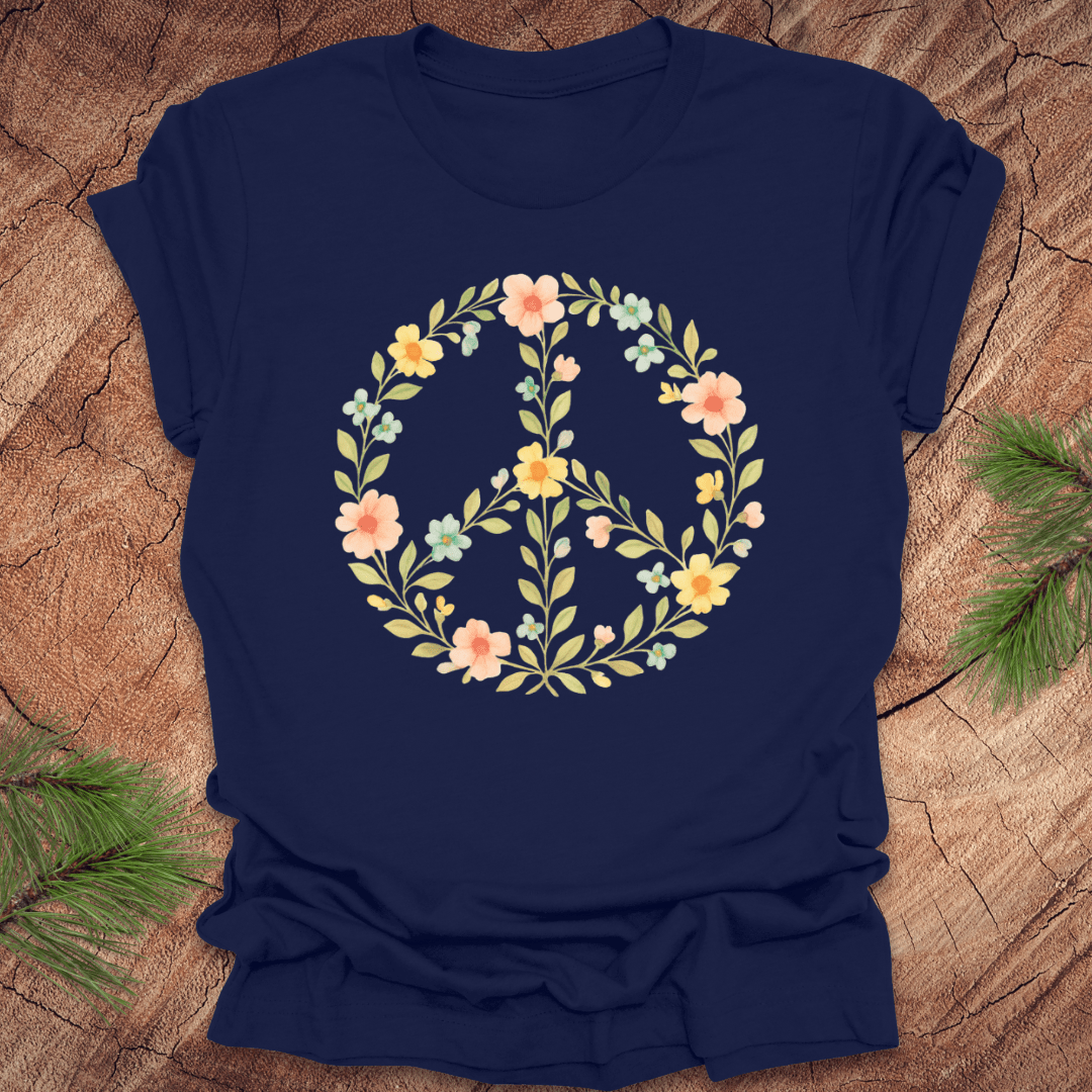 Navy blue t-shirt with a peace sign made of flowers on a wood background.