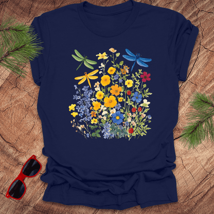 navy blue t-shirt with wildflowers and dragonflies on a wood background.