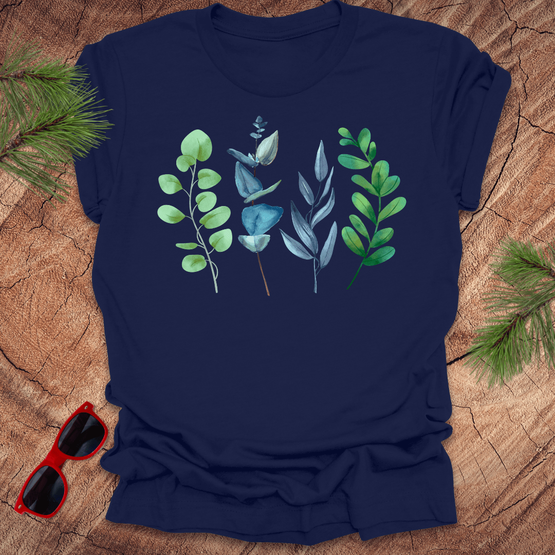 Navy blue t-shirt with leaf designs on a wooden surface with sunglasses and greenery.