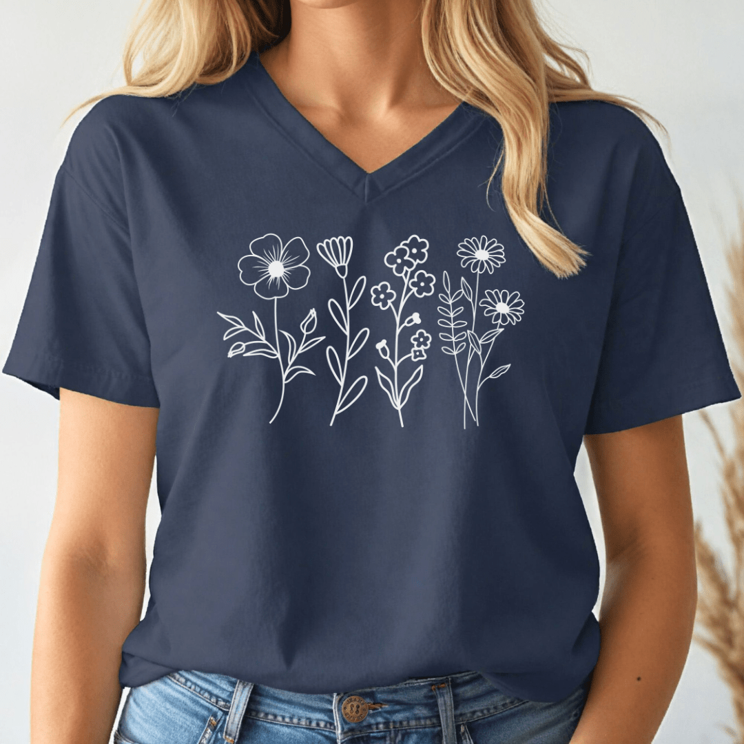 Navy blue v-neck t-shirt with white floral designs worn by a person