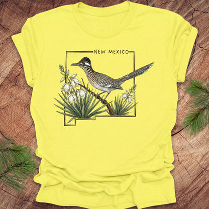 Yellow t-shirt with a roadrunner and New Mexico design on a wooden surface