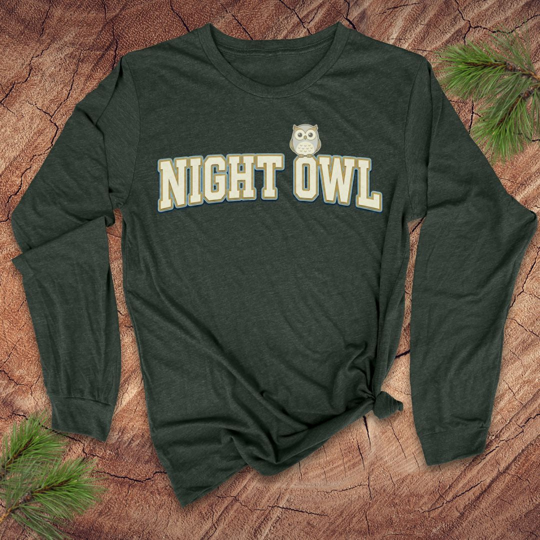 Green long-sleeve shirt with 'NIGHT OWL' text on a wooden surface