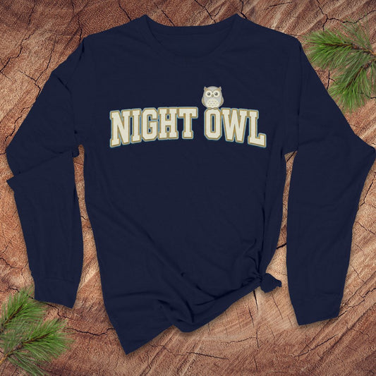 Navy blue long-sleeve shirt with 'NIGHT OWL' text and owl graphic on a wooden surface.