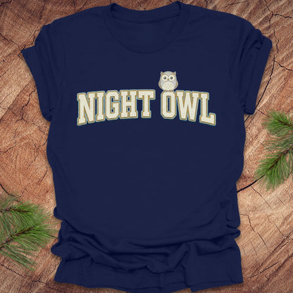 Navy blue t-shirt with 'NIGHT OWL' text and owl graphic on a wooden surface.