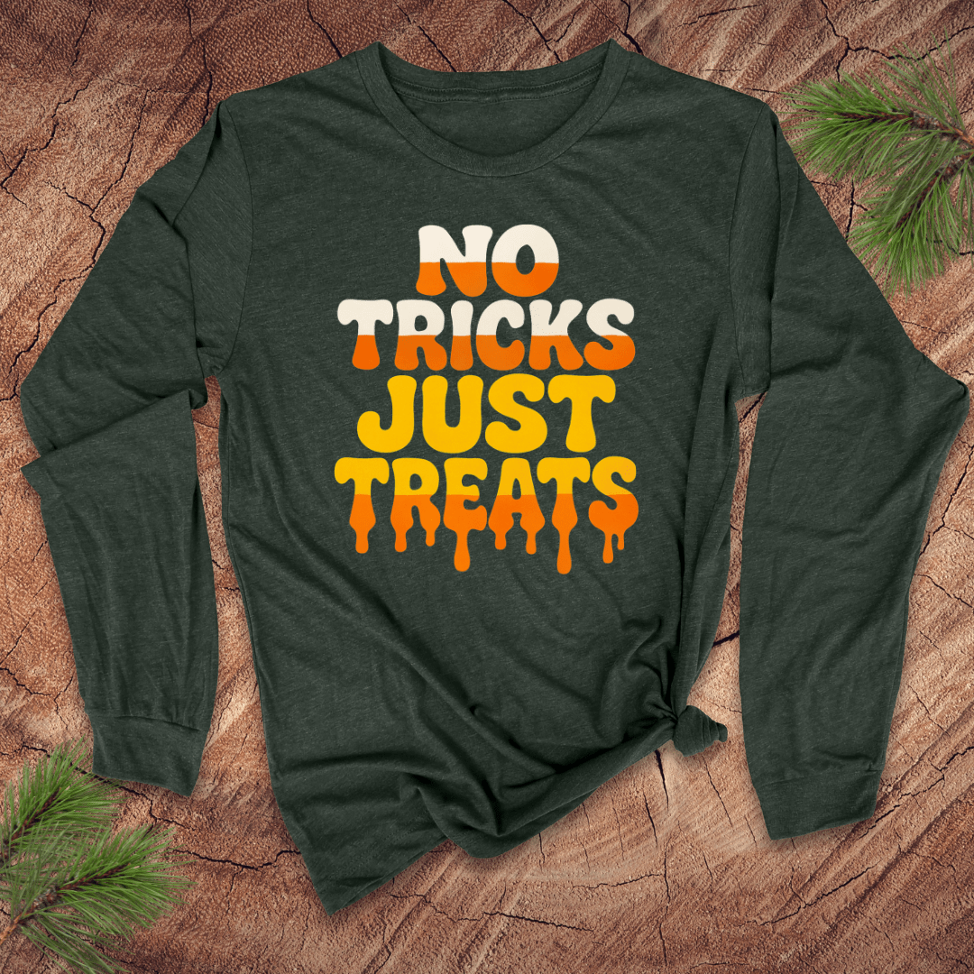 Green long-sleeve shirt with 'No Tricks Just Treats' text on a wooden surface