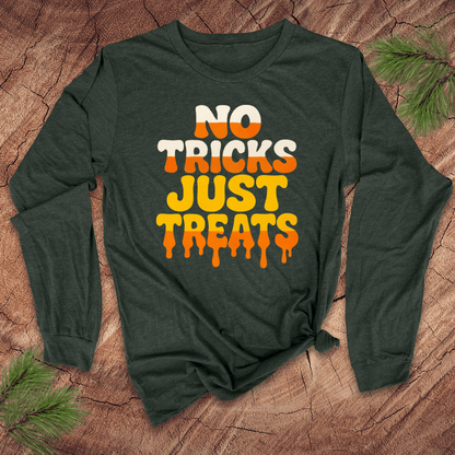 Green long-sleeve shirt with 'No Tricks Just Treats' text on a wooden surface
