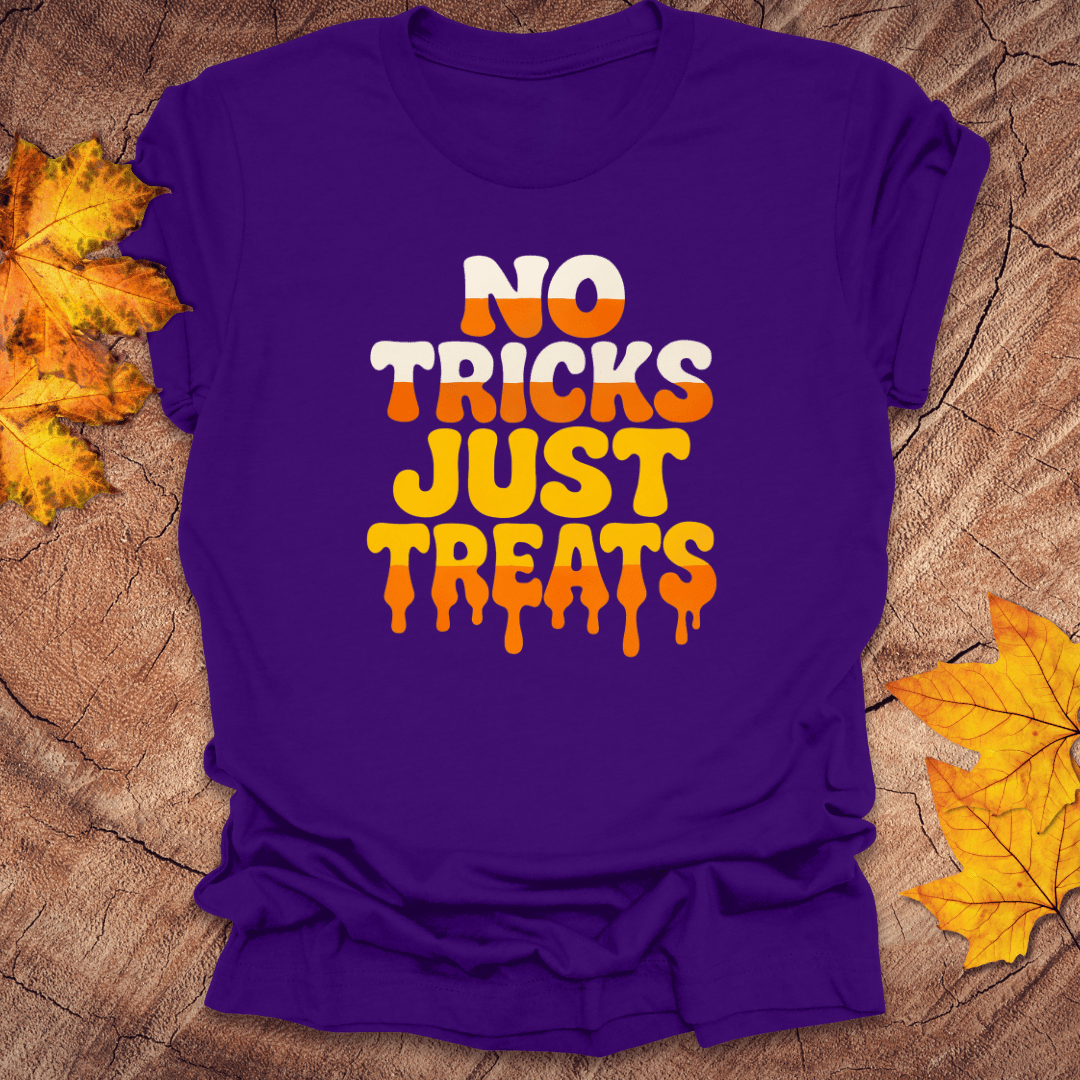Purple t-shirt with 'No Tricks Just Treats' text on a wooden surface with fall leaves.