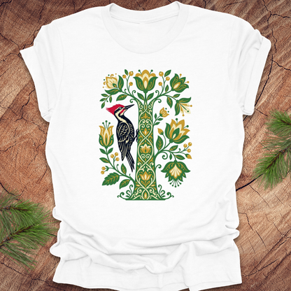 White t-shirt with a woodpecker design on a wooden surface