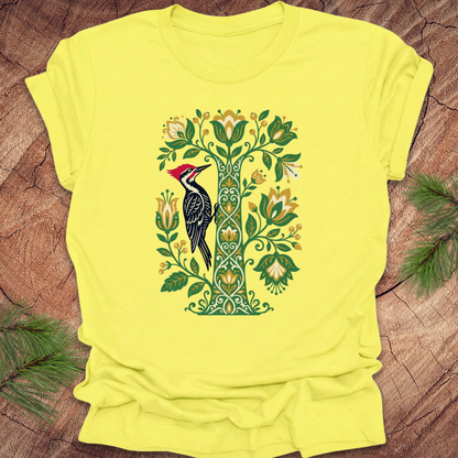 Yellow t-shirt with a woodpecker design on a wooden surface