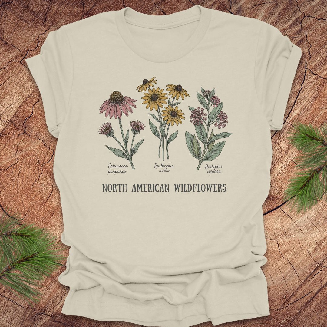 Beige t-shirt with North American wildflowers design on a wooden surface