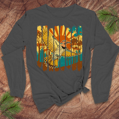 Gray long-sleeve shirt with a colorful northern flicker bird and sunrise design on a wooden surface